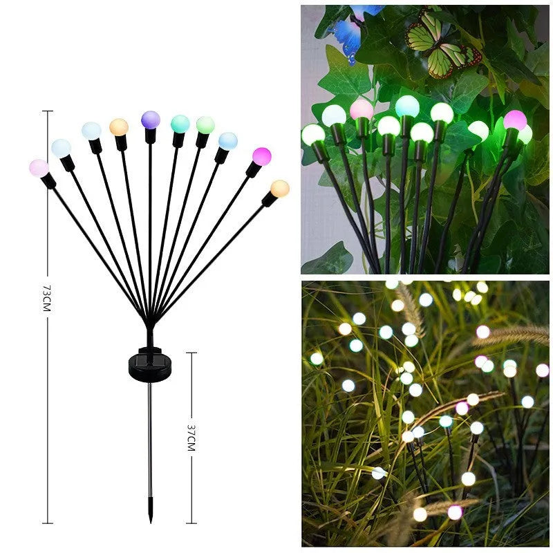 Solar-powered LED firefly lawn light with ground stake inserted in grass