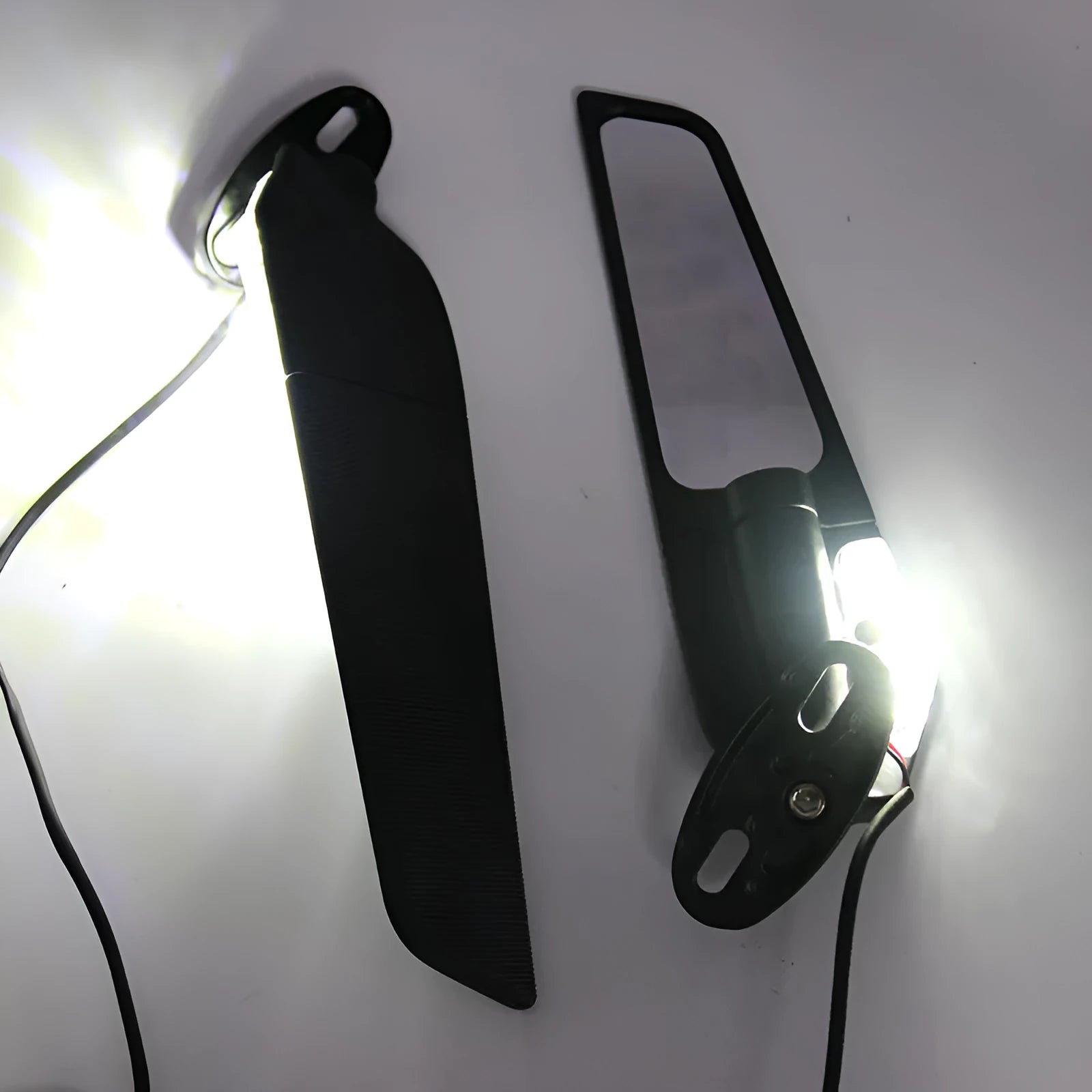 Pair of spoiler-shaped motorcycle rearview mirrors with yellow LED lights and convex lenses.