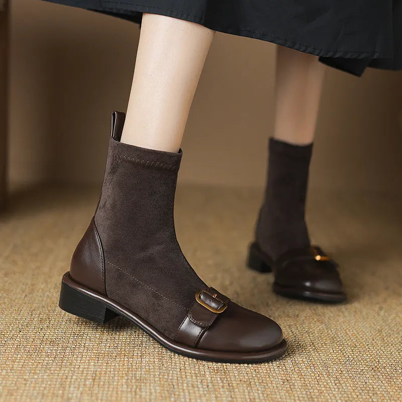 Women's black casual low-heel ankle boots with belt buckle detail and front lace-up closure.