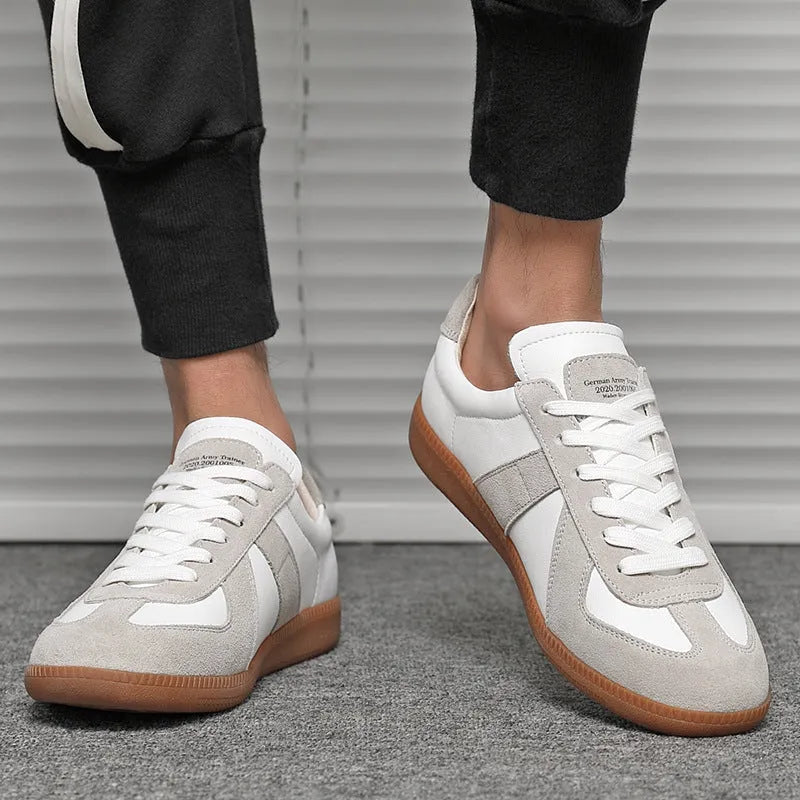 White Japanese-inspired retro unisex sneakers with low-top lace-up design on a rubber sole