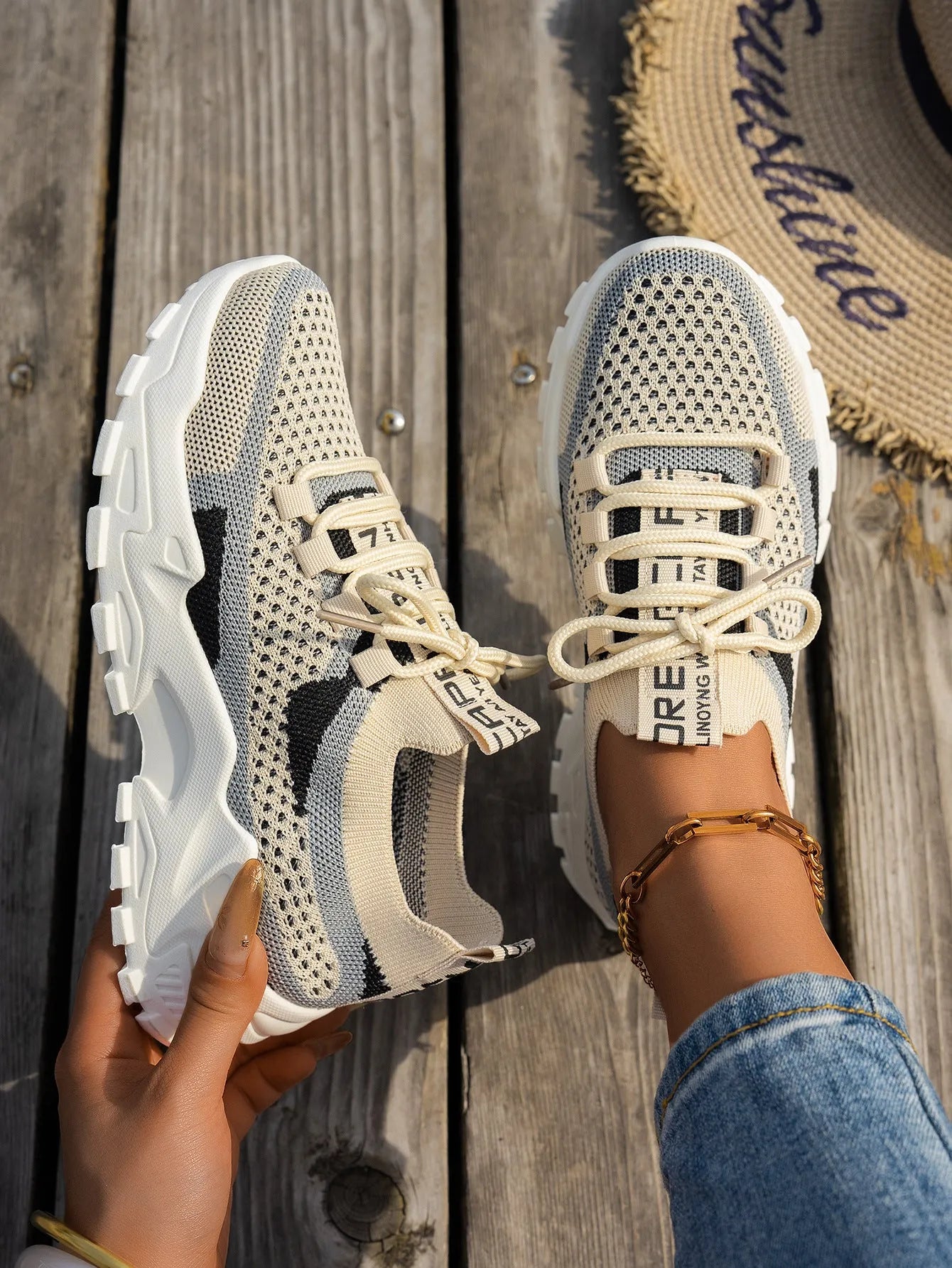 Women's Flyknit Mesh sneakers in a neutral colour showing lace-up design and rubber sole.