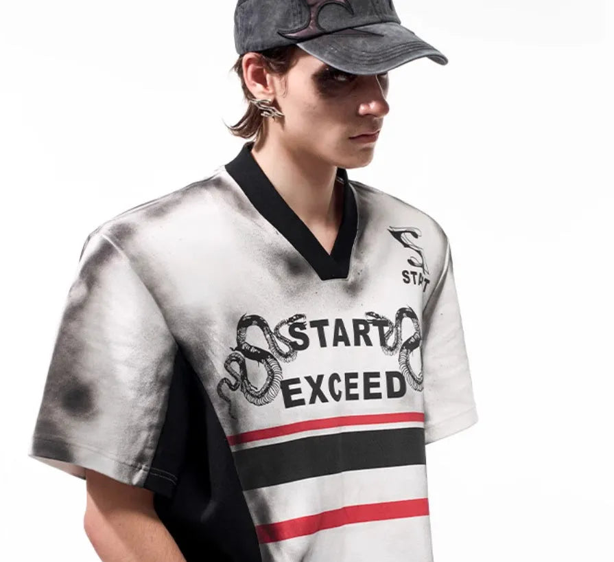 Women's V-neck short sleeve top with a black and white letter snake pattern print and padded shoulders.