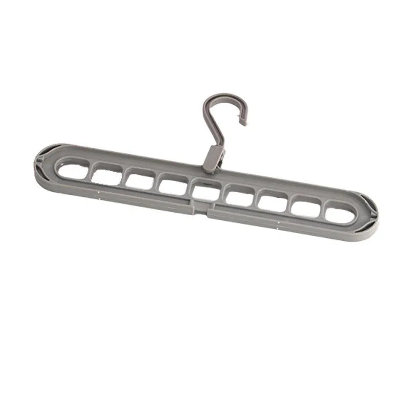 Green plastic nine-hole hanger folded flat showing multiple trouser hanging points