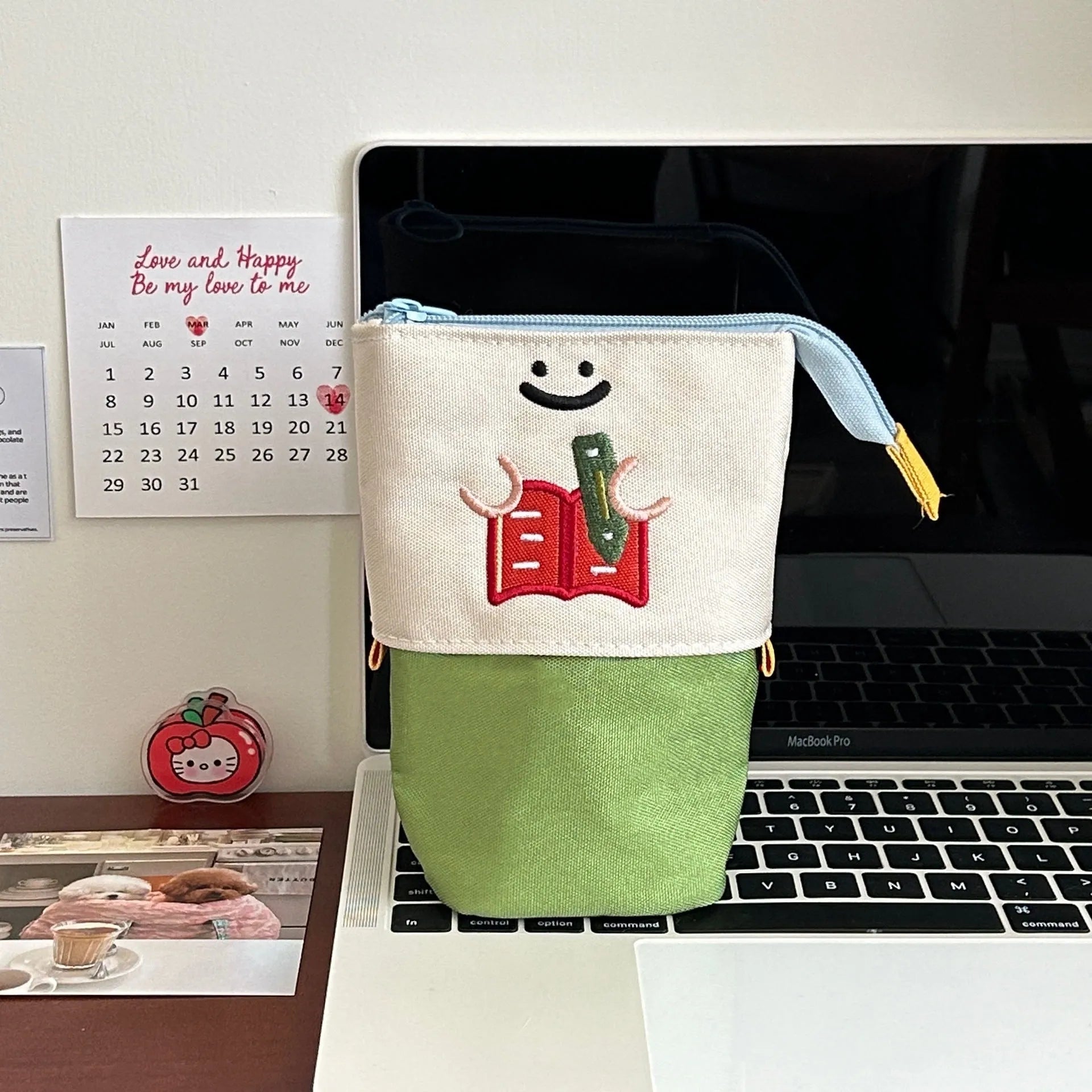 Brown and green cartoon-style collapsible Oxford cloth pencil case showing zip and 17x14cm size.