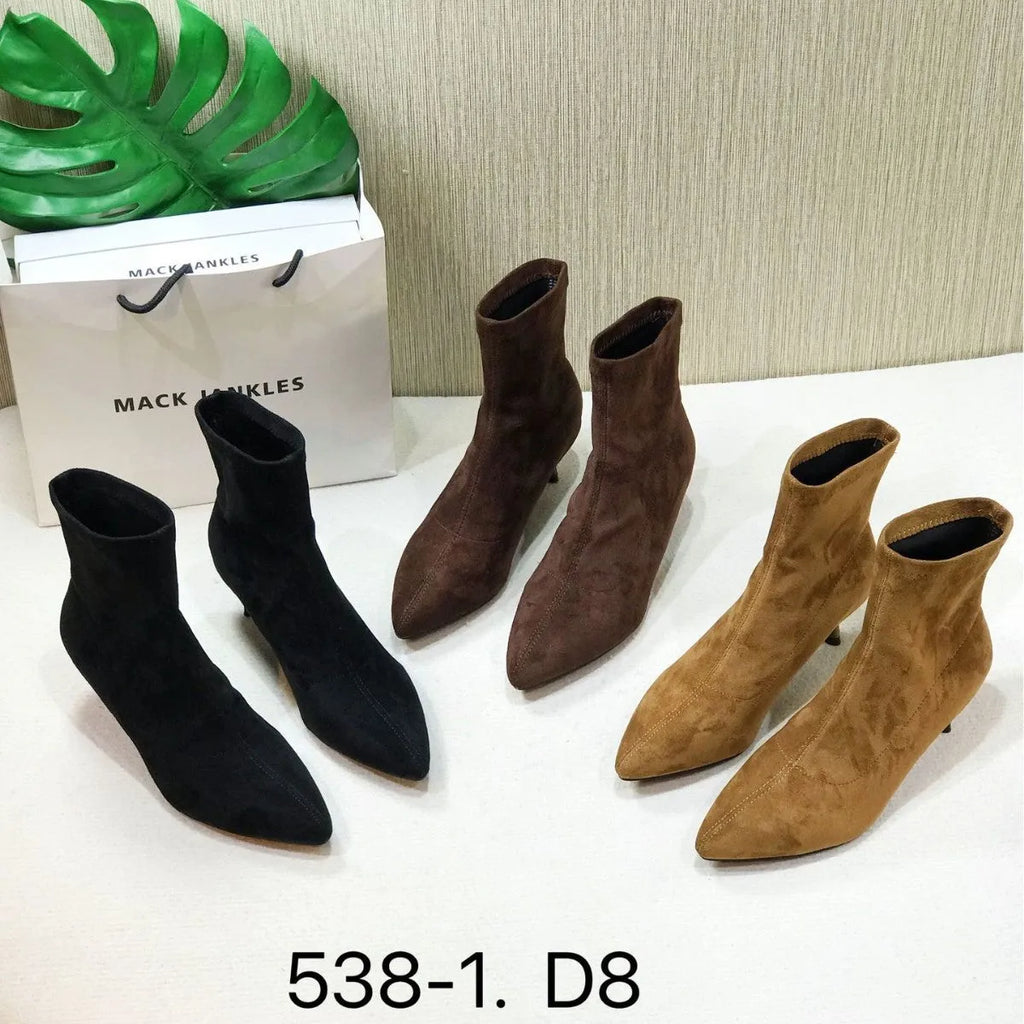 Black pointed toe ankle boots with stiletto heels and mid-calf length