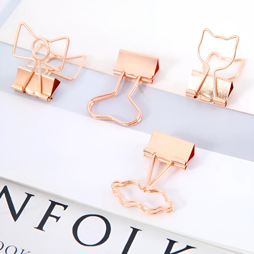Gold-plated decorative binder clips showing flamingo, love, clouds, cat, cactus and bow designs