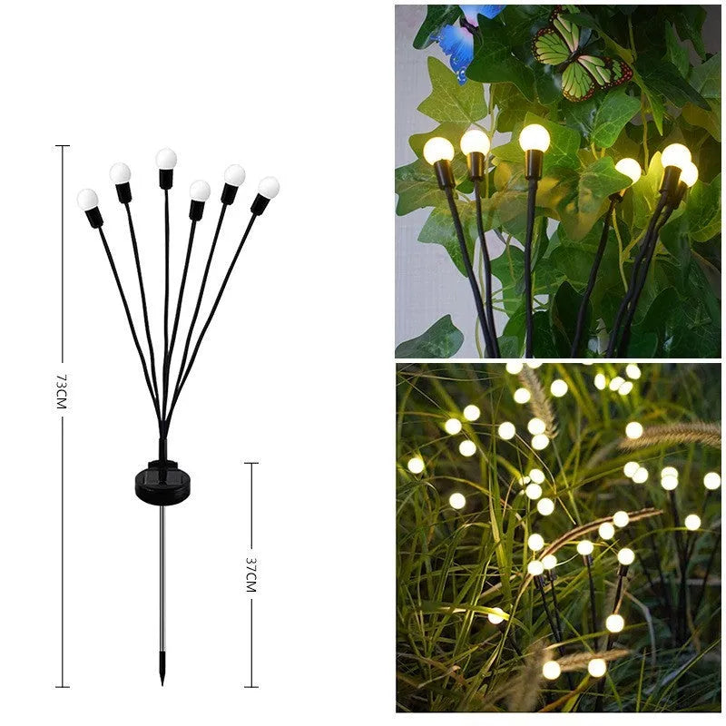 Solar-powered LED firefly lawn light with ground stake inserted in grass