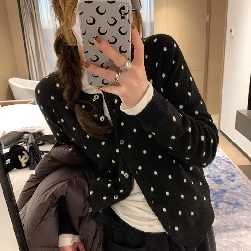 Grey Korean-style knitted cardigan with crocheted flower detail on mannequin