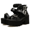 Black women's Roman style platform sandals with a chunky heel, round toe, back zipper, and decorative buckle.