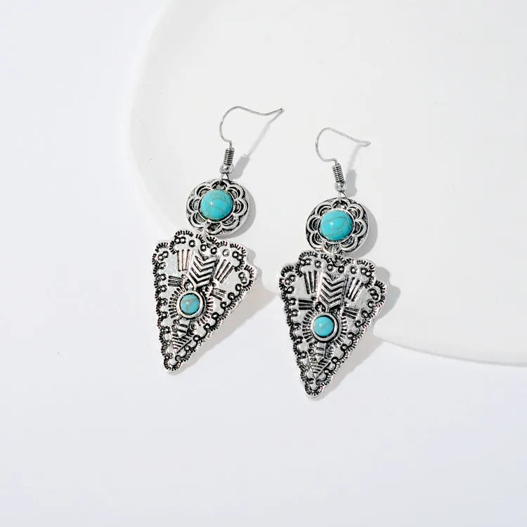 Pair of retro alloy earrings for women in triangle style with national design for travel and photo outfits.