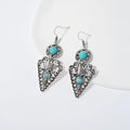 Pair of retro alloy earrings for women in triangle style with national design for travel and photo outfits.