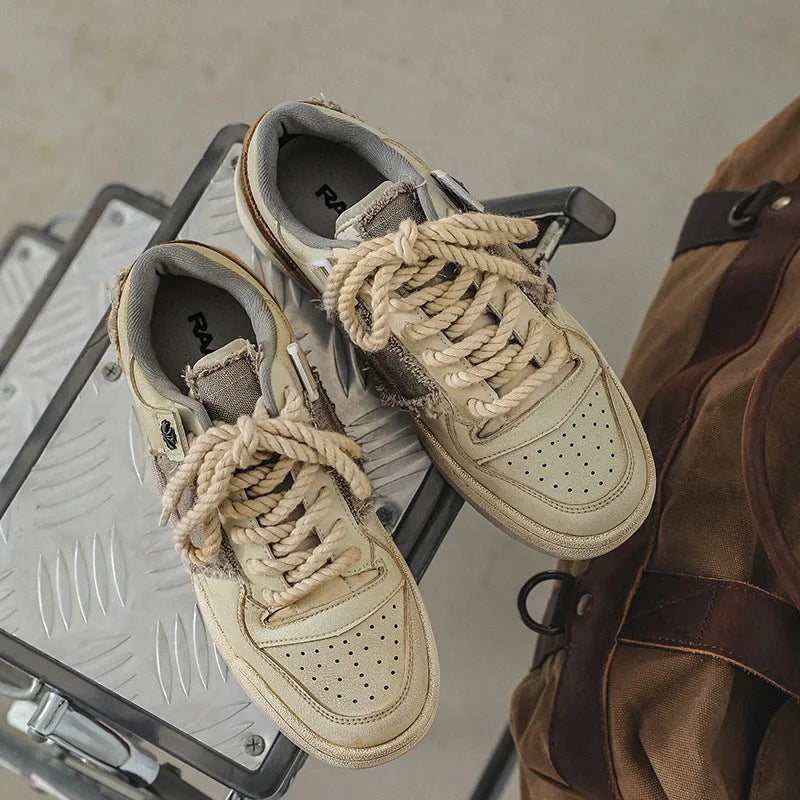 Beige vintage skateboard shoes with patch detailing, low-top design, and round toe