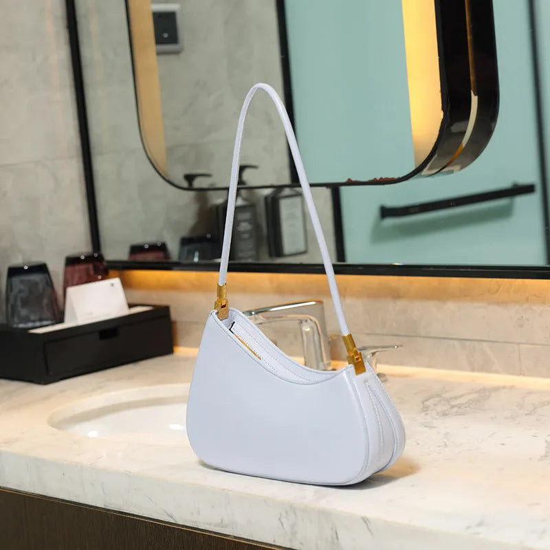 Women's oval retro underarm handbag in PU leather, shown in one of seven colours with a single strap and sewing line detail.