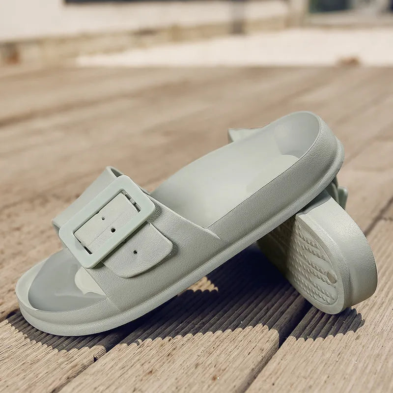 Grey Blue women's EVA flip-flop slippers with a silver buckle strap on a white background.