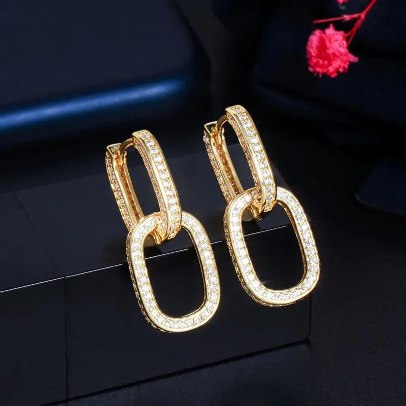 Pair of copper geometric U-shaped earrings with inlaid zircon in white gold colour