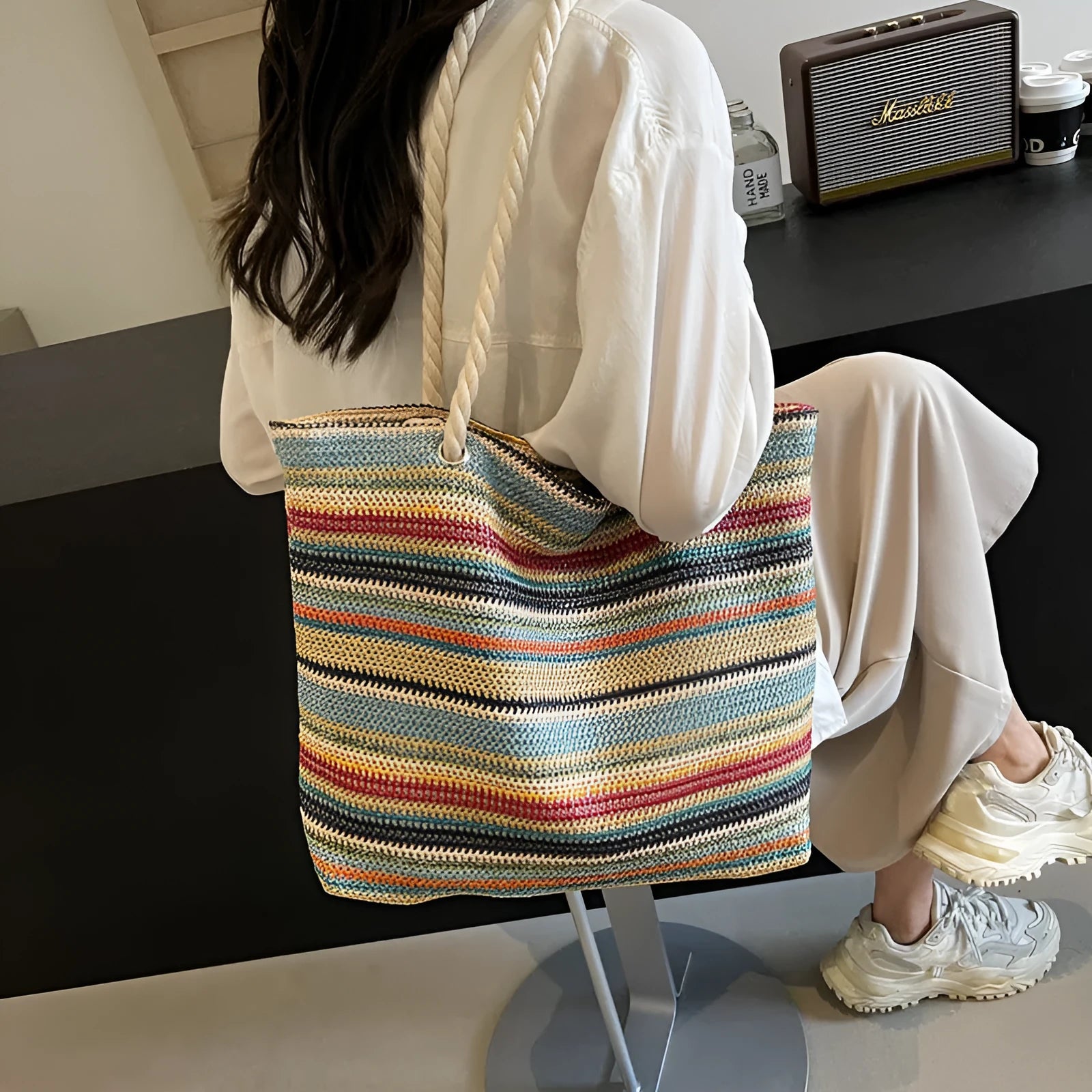 Blue woven nylon shoulder bag with straw-inspired basket construction and polyester lining
