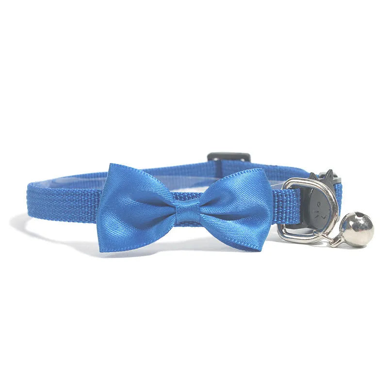 Adjustable striped nylon cat collar with a bell shown in multiple colours including red, blue, green, and pink.