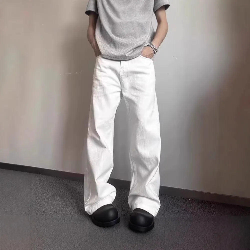 Men's white loose straight-leg cotton denim jeans with wide cut and zipper fly