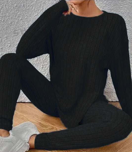 Women's black and blue sunken stripe patterned two-piece polyester homewear set with top and loose-fit pants.