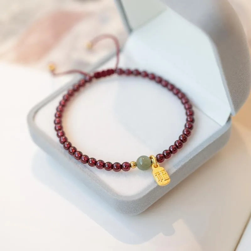 Hand-woven red rope bracelet with crystal beads in strawberry quartz or garnet variants