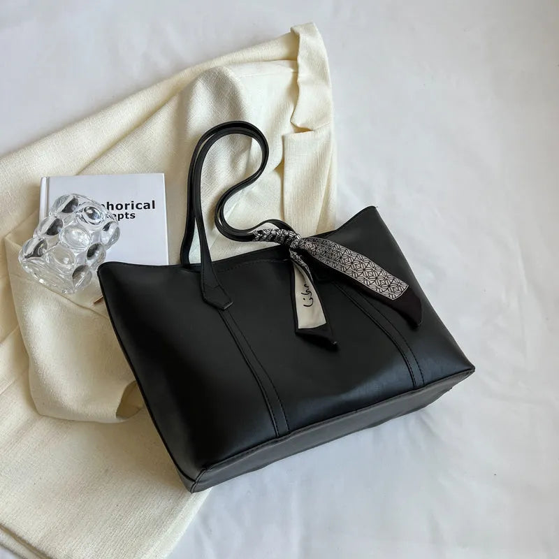 Women's soft large tote bag in a chosen colour, showing outer pockets and sewing detail.