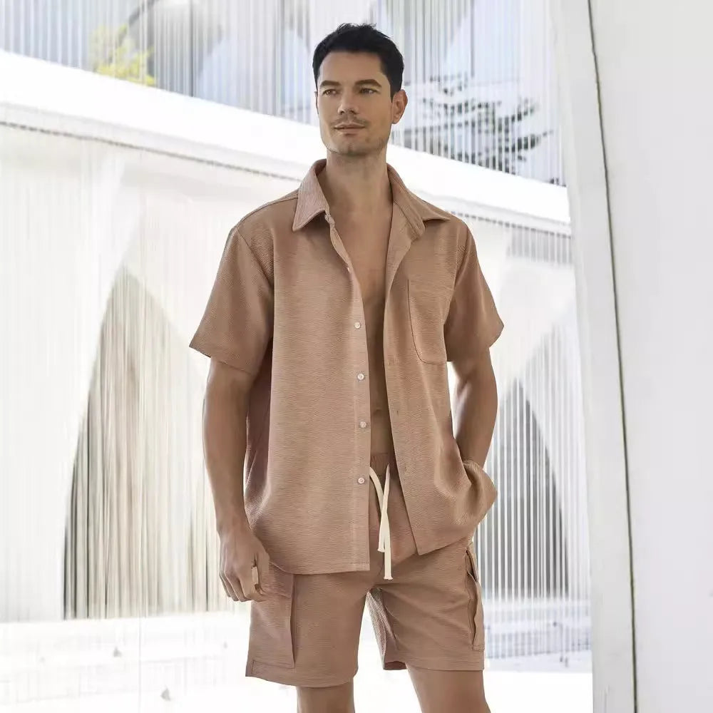 Beige polyester short sleeve top and elastic waist shorts two-piece set laid flat.