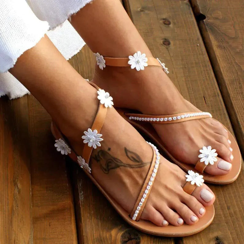 Brown ladies flat sandals with flower decorations and herringbone toe pattern