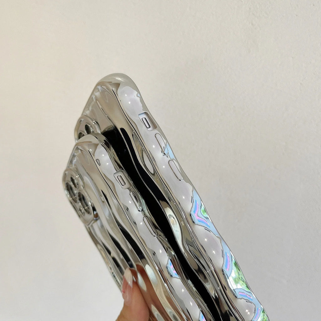 iPhone 17 Pro Max in a silver electroplated TPU case with a textured wave stripe pattern on the back.