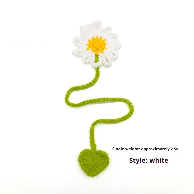 Hand-crocheted wool bookmark with flexible wire core and little daisy design in milk cotton yarn