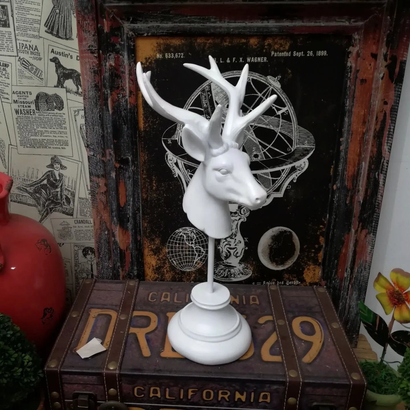 Tall black natural resin animal sculpture decoration on a wooden shelf.