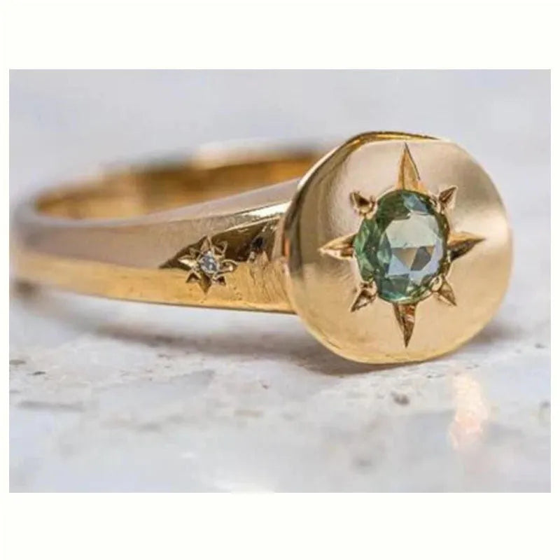Golden oval ring with star asterism design and adjustable opening mechanism
