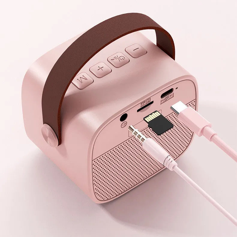 Compact white wireless Bluetooth speaker with microphone, showing USB port.