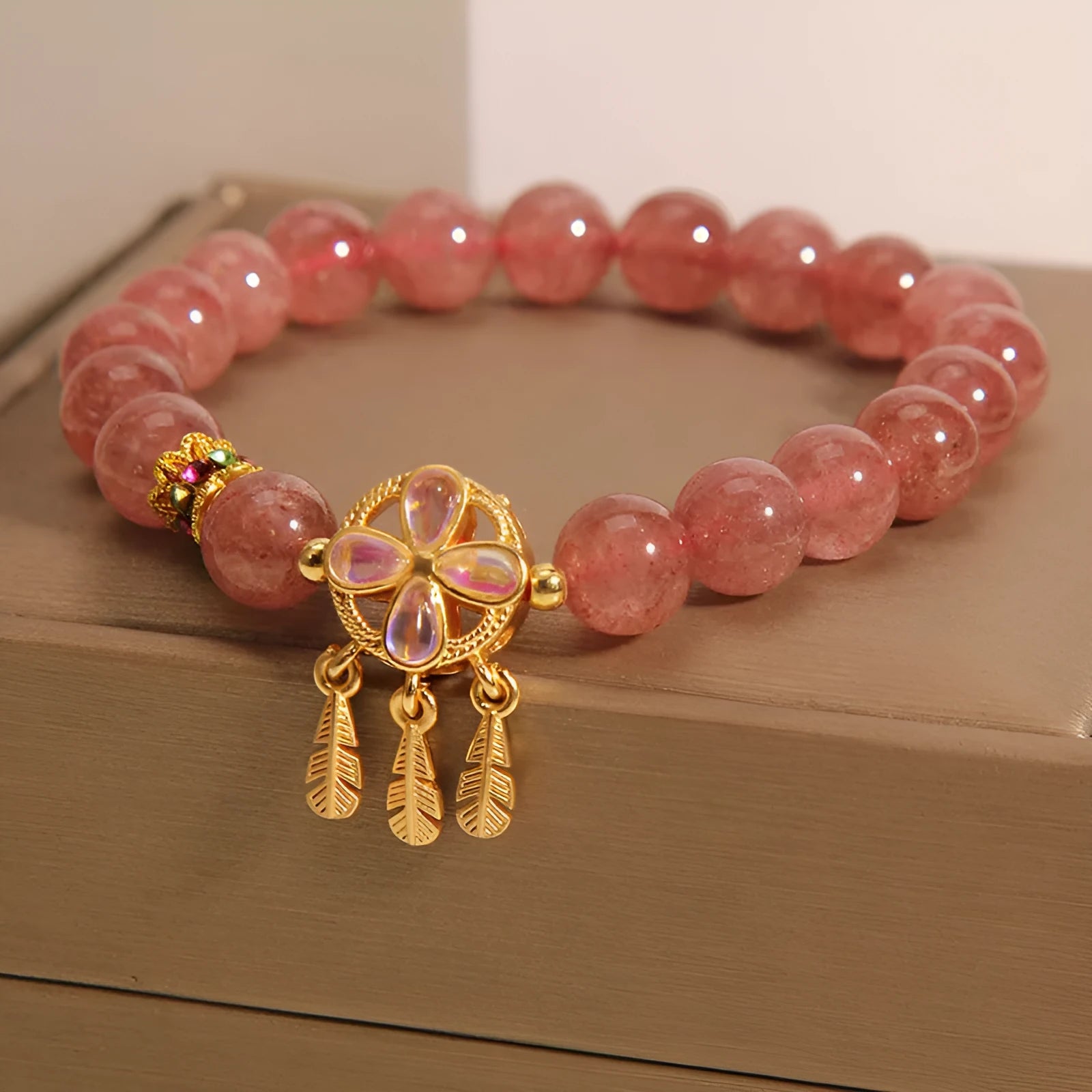 Women's crystal bracelet with strawberry quartz dream catcher ball pendant, original design.