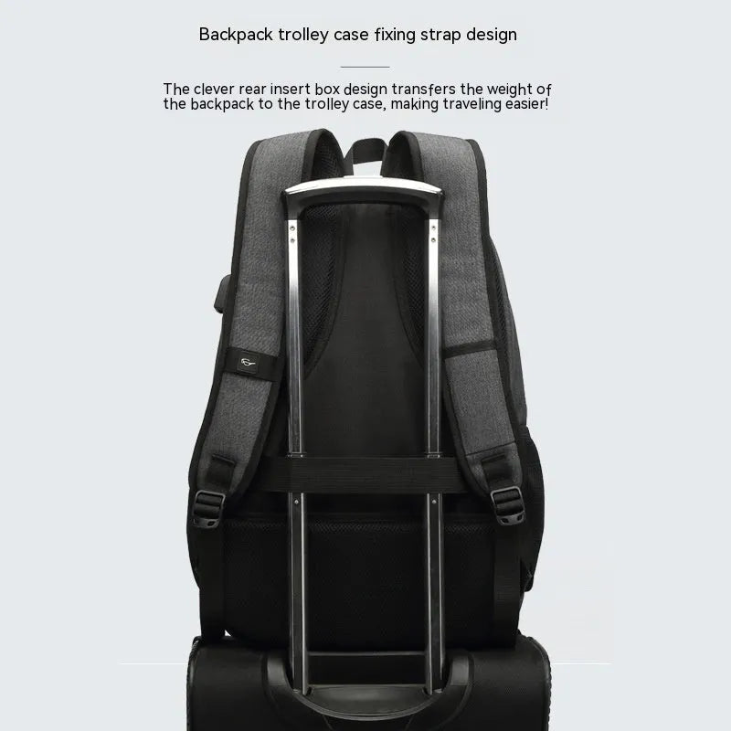 Gray nylon backpack with USB charging port and trolley sleeve on a suitcase.