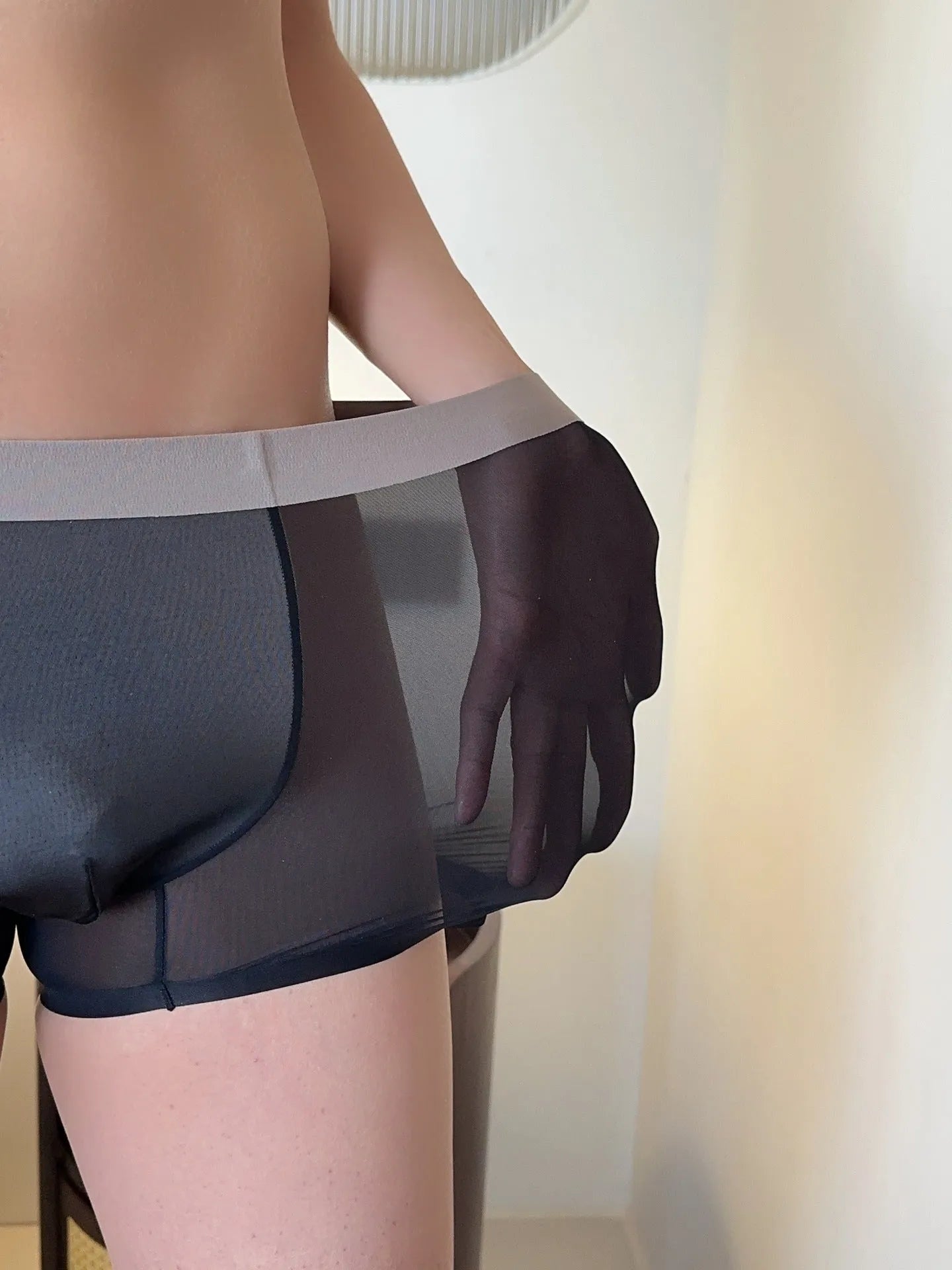 Seamless men's boxer in ice silk fabric showing honeycomb crotch design and mid waist.