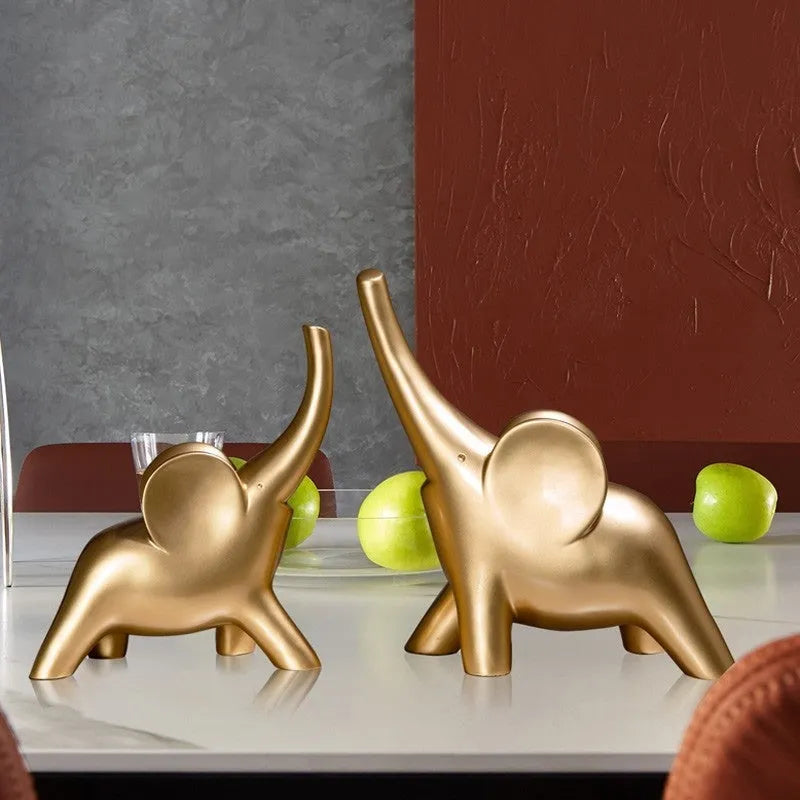 Minimalist rose gold and white resin elephant ornaments on a shelf, showing large and small sizes.