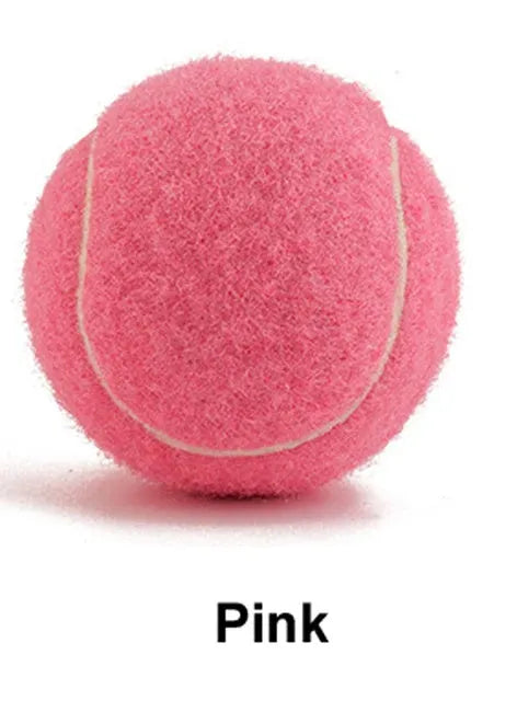 6.3 cm diameter solid rubber dog tennis ball in assorted bright colours on a green lawn.