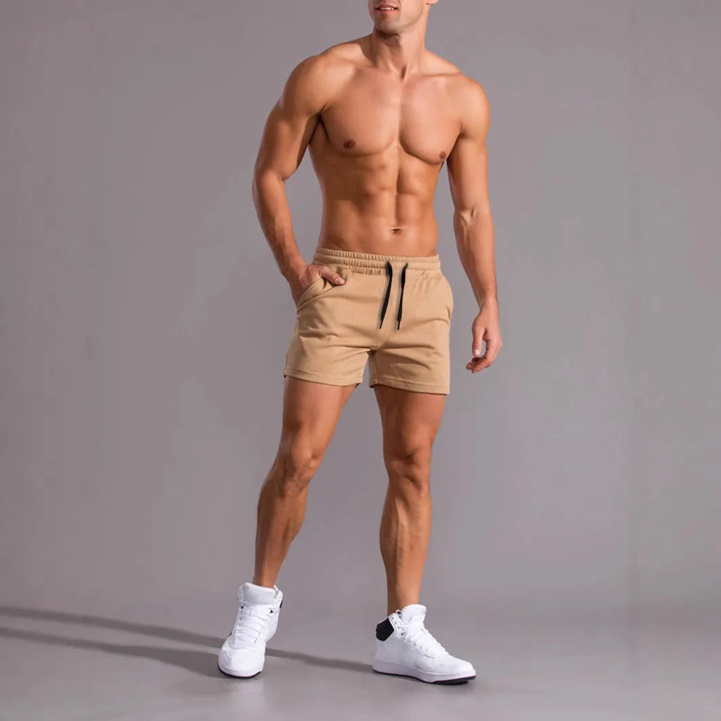 Three pairs of men's solid colour drawstring shorts in a pack, shown in black, khaki, and light brown.