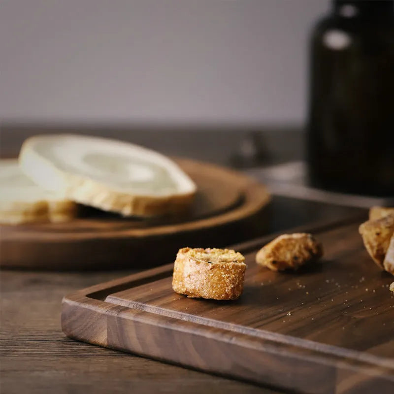 Black walnut wood cutting board with juice groove and side handle shown in three size options