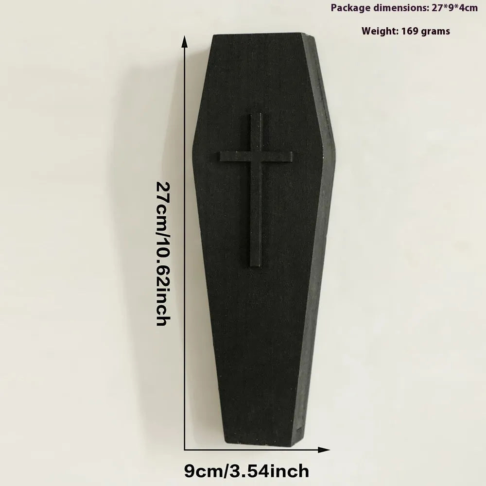 Black cross-shaped wooden wall shelf for home decoration, measuring 27 by 9 centimetres.