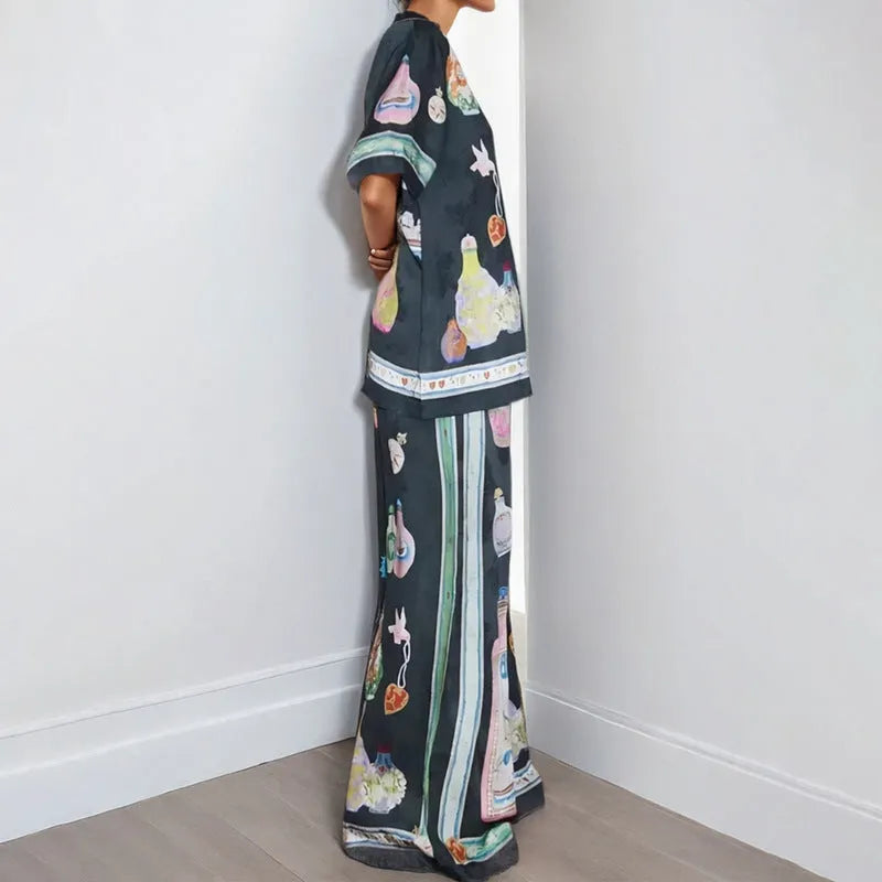 Black women's pyjama set with cartoon print pattern showing matching trousers and top