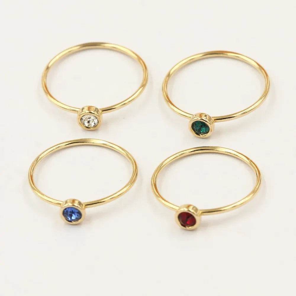 14K gold plated zircon knuckle ring on finger showing copper base with decorative stones