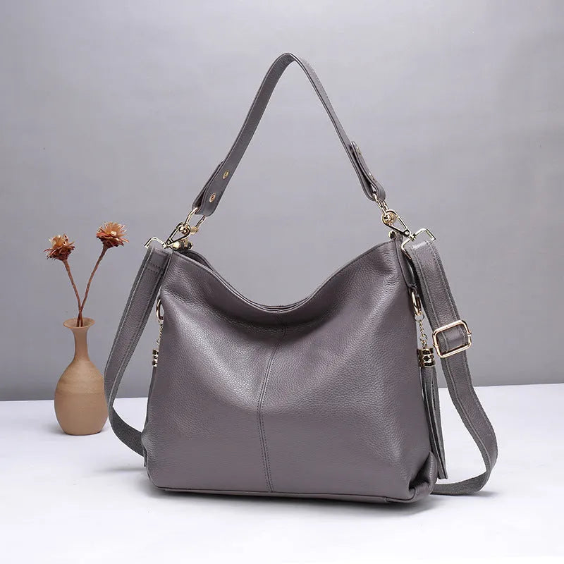 Square vertical genuine leather crossbody bag with multiple internal compartments including phone pocket.