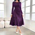 Purple women's long sleeve dress with ruffles, a round neck, and a mid waist fit on a hanger.