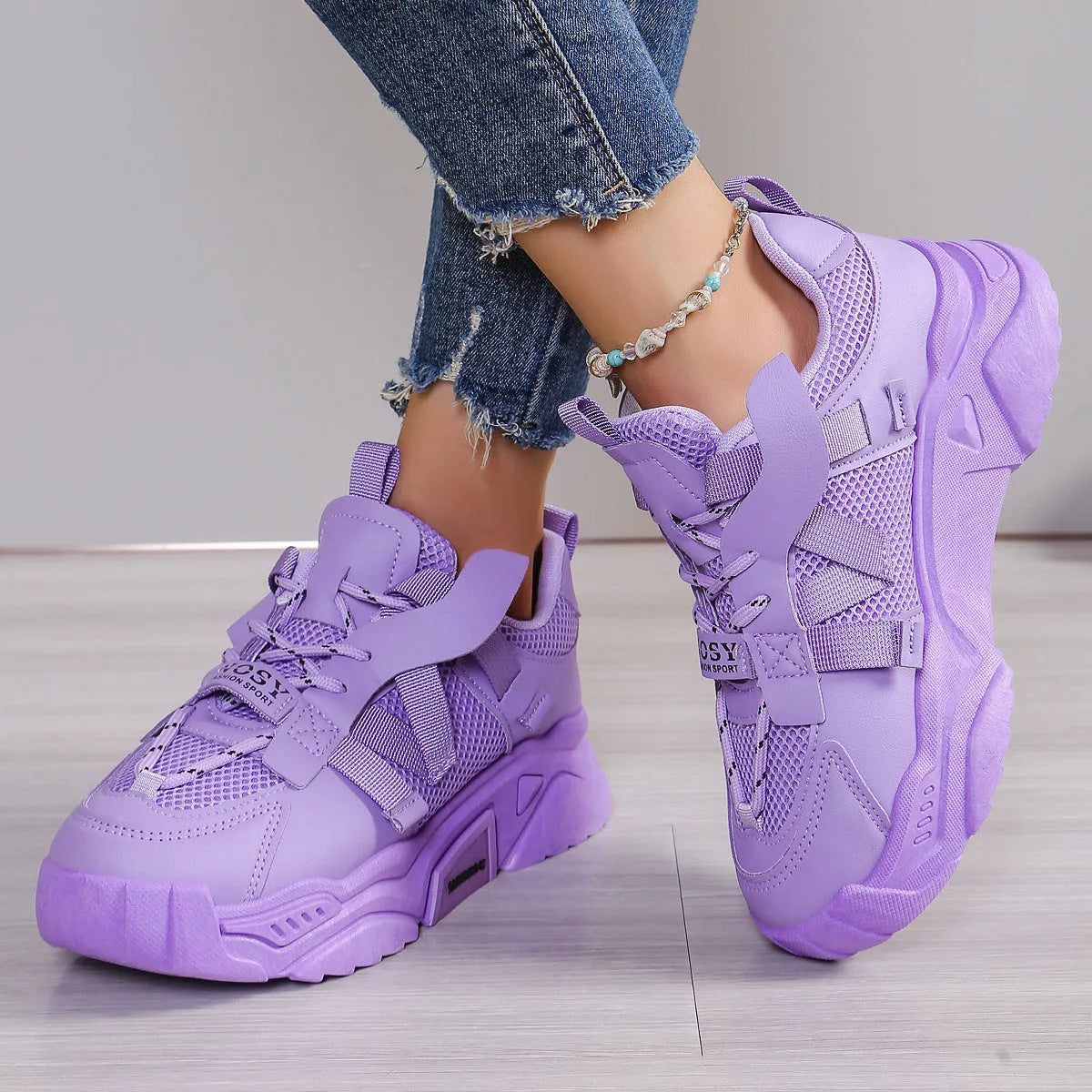 Women's platform sneakers in purple with mesh upper, animal pattern detail, and lace-up front.