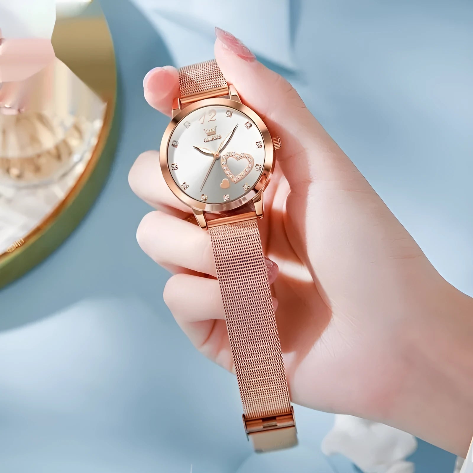 Women's mesh strap watch with rose shell casing showing six face colour options