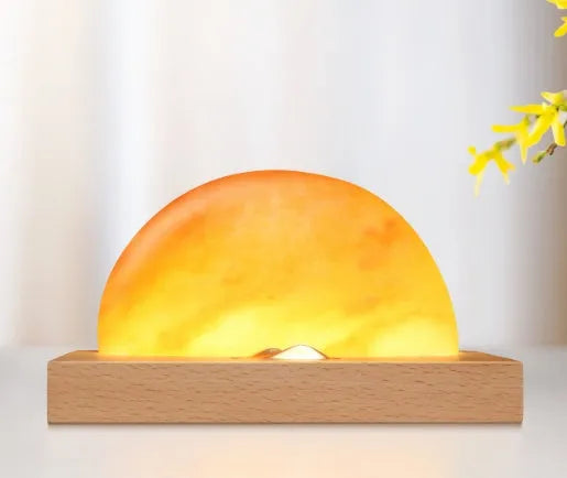 Natural crystal salt lamp with solid beech wood base and integrated Qi wireless phone charging pad.