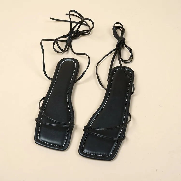 Women's flat sandals with ankle bandage strap in white, featuring a square toe and front lace-up.