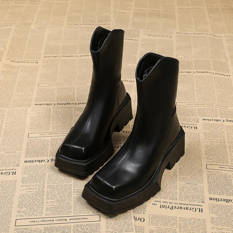 Black women's platform Martin ankle boots with a square toe, high heel, and back zipper on a white background.