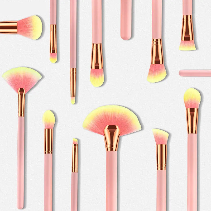 Pink 10-piece makeup brush set with nylon wool bristles and wooden handles laid out on a flat surface